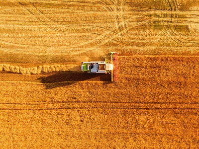 Harvester machine working in field, LALS Stock | Shutterstock